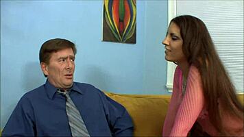 She fiercely tugs his tie, flashing her shaved pussy upskirt.