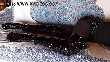 brunette milf in total black fishnets pantyhose and over the knee boots