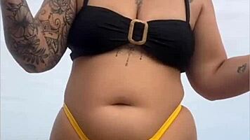 Young african woman in tight yellow bikini at usa beach