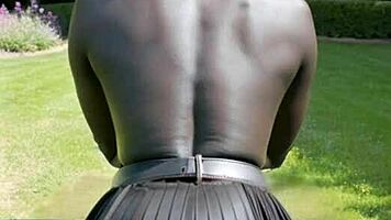 ebony beauty flashes big natural tits behind leather skirt outdoors