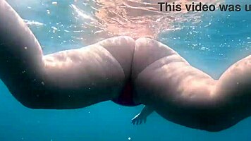 Pawg slips into thong bikini for underwater swim bath in crystal waters