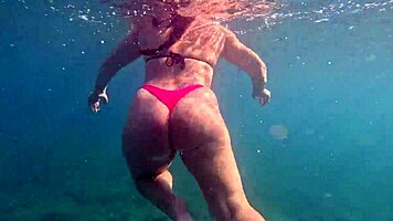 Pawg slips into thong bikini for underwater swim bath in crystal waters