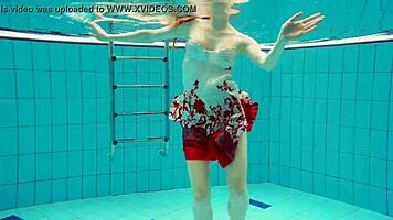 hairy brunette marketa swims underwater in tight pool