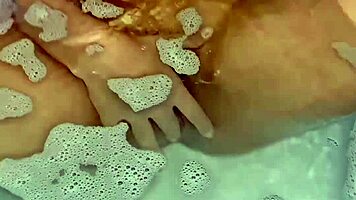 Latina babe fingers herself sensually to explosive bath orgasm