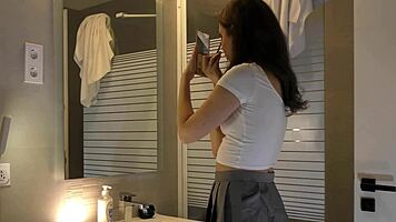 alicia poses in plaid skirt and stockings bathroom