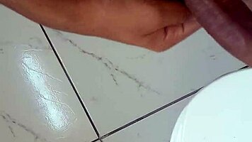 Brazilian solo ass tease handjob strokes huge cock in bathroom mirror