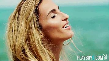 Petite blonde Cara Mell seductively strips nude on sun-kissed beach