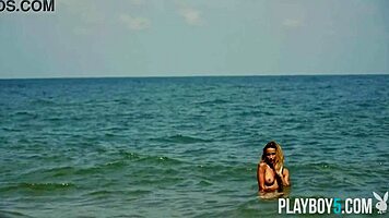 Petite blonde Cara Mell seductively strips nude on sun-kissed beach