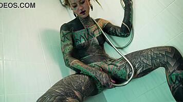 heavily tattooed model fingers her ass and squirts in shower