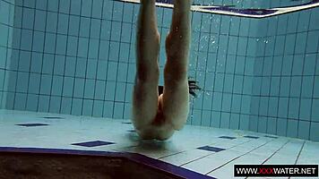 Brunette with long hair bathes underwater