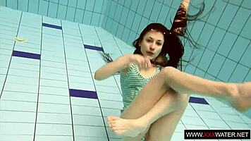 Brunette with long hair bathes underwater