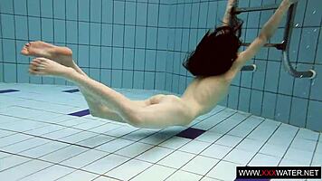 Brunette with long hair bathes underwater