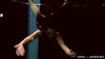 Brunette with long hair bathes underwater