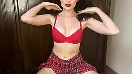 Teen brunette strips with a teasing flair in a captivating display.