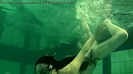 Young European 18yo Kristina Andreeva has a tight body and shaven twat; she indulges nude pool swimming