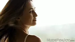 One of the slender teenage brunette named Edessa G performs a solo, erotic dance while her petite breast is partly revealed