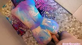 brunette teen covered in colors, getting pleasured with blowjob