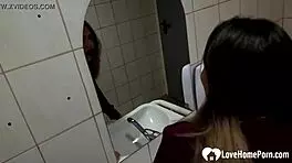 A beautiful slim 18 year old girl is having it in the rest room of the night club