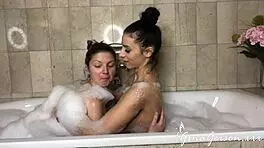 Nelly Kent and Gina Gerson suck a cock in the lavatory