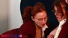 Two girls in red uniforms engaged in tender lesbian sex