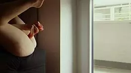 Exhibitionist masturbating at home, showing neighbours