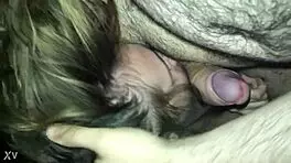 The teen is giving a blowjob, sucking and licking the young guy's cock