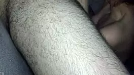 The teen is giving a blowjob, sucking and licking the young guy's cock