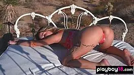 Petite blondie reveals small boobs in desert.