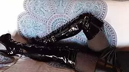 brunette milf in total black fishnets pantyhose and over the knee boots