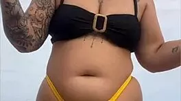 Young african woman in tight yellow bikini at usa beach