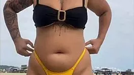 Young african woman in tight yellow bikini at usa beach
