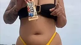 Young african woman in tight yellow bikini at usa beach