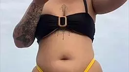 Young african woman in tight yellow bikini at usa beach