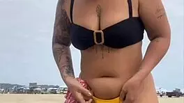 Young african woman in tight yellow bikini at usa beach