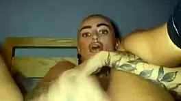 Tattooed goth slut fingers herself raw