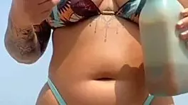 found this babe beach let him rub oil swollen pussy lips