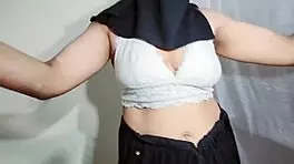 Arabic beauty in black hijab sways hips and bounces curves to exotic beats