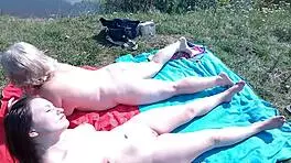 Mature Babe and Young Hottie Naked Sunbathing Public Beach