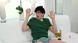 Curvy MILF spots young guy stroking and tempts him with her big tits