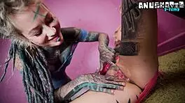 Inked alt girls tease each other with intense strap-on play