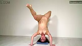 curly russian gymnast stretches naked on sofa showing flexible legs and pussy