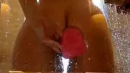 Appetizing ass girl spreads wide for pink toy fun in steamy shower.