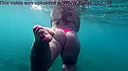 Pawg slips into thong bikini for underwater swim bath in crystal waters