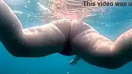 Pawg slips into thong bikini for underwater swim bath in crystal waters