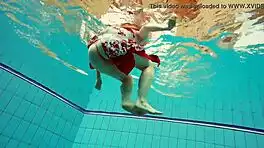 hairy brunette marketa swims underwater in tight pool