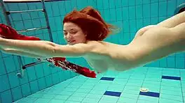 hairy brunette marketa swims underwater in tight pool