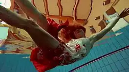 hairy brunette marketa swims underwater in tight pool