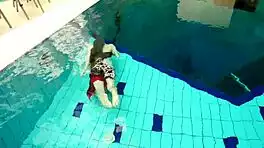 hairy brunette marketa swims underwater in tight pool