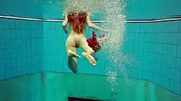 hairy brunette marketa swims underwater in tight pool