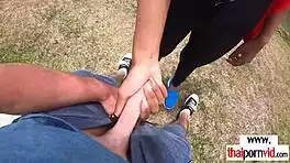 cute petite thai teen sucks massive white cock outdoors